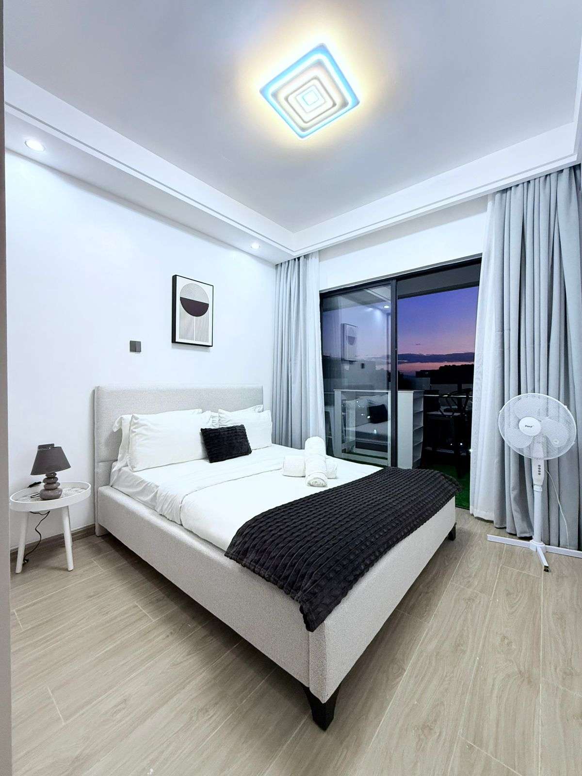 Furnished bedroom with balcony access at Oak Classic Residency in Kilimani