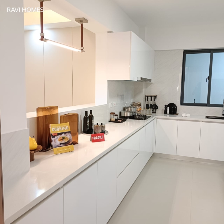 Royal Legend Residence modern kitchen featuring white fitted cabinets, quartz-look countertops, built-in gas hob, extractor hood, and large window.
