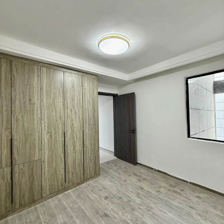 Bedroom with fitted wardrobes at Alina Harbour apartments in Kilimani