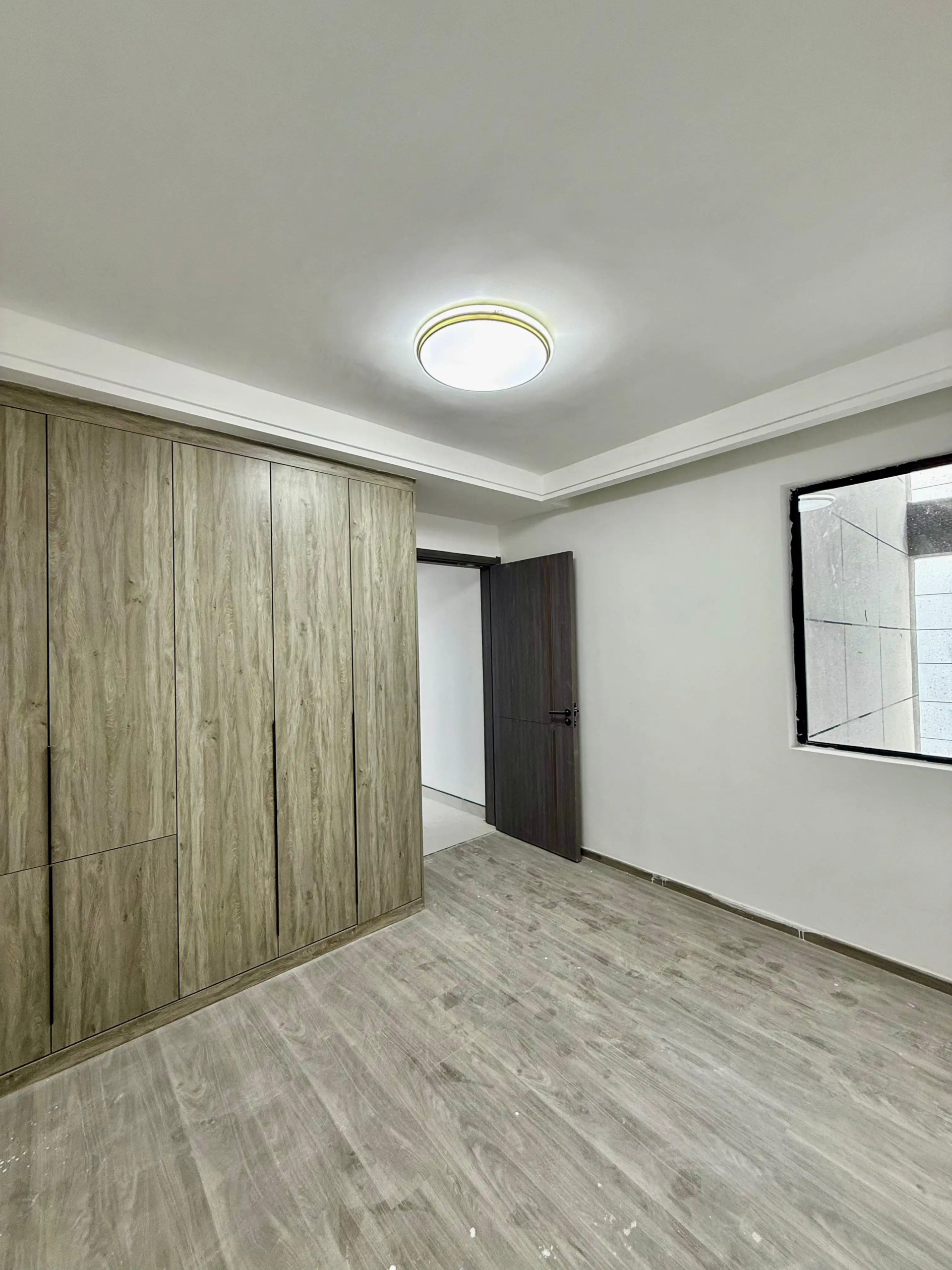 Bedroom with fitted wardrobes at Alina Harbour apartments in Kilimani