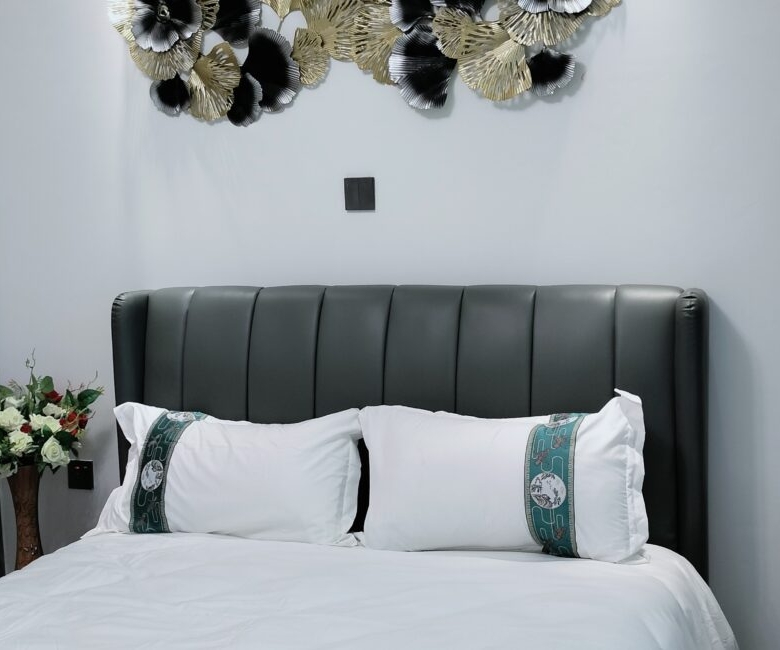 Bedroom at Alina Valley Apartments Kilimani with decorative wall art