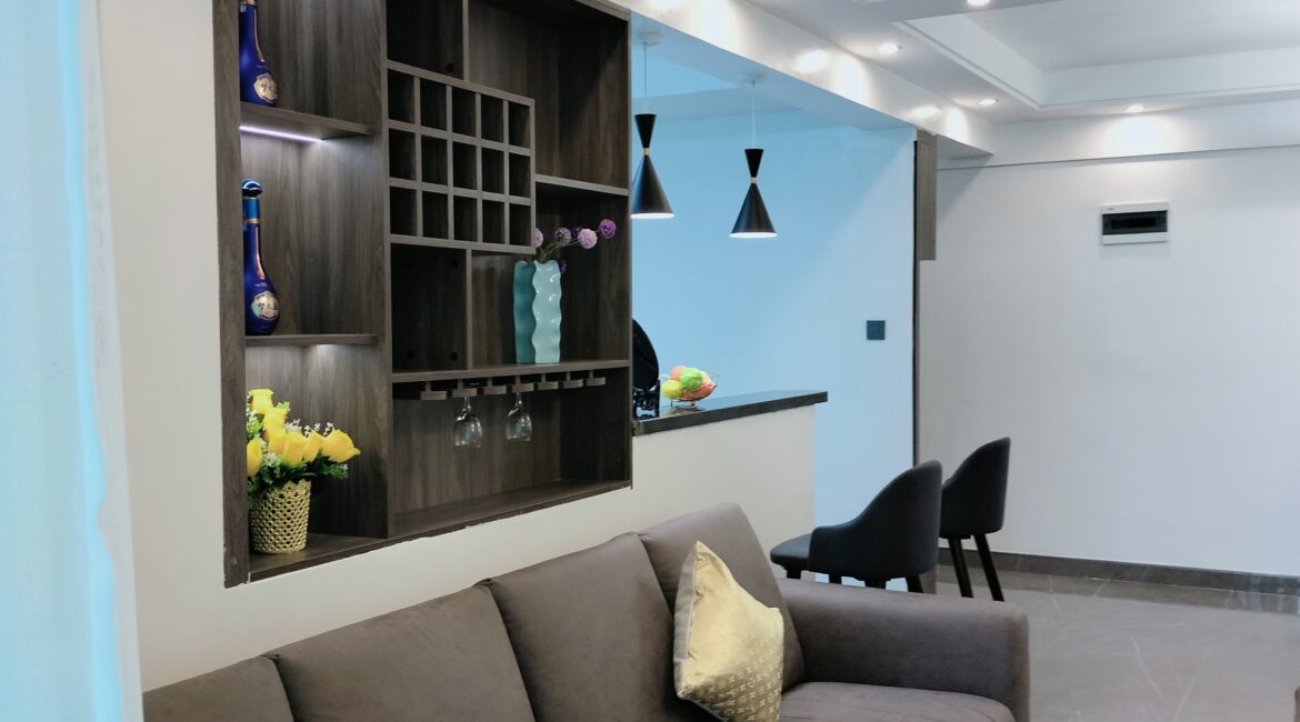 Lounge at Alina Valley Apartments Kilimani with built-in shelf and kitchen view
