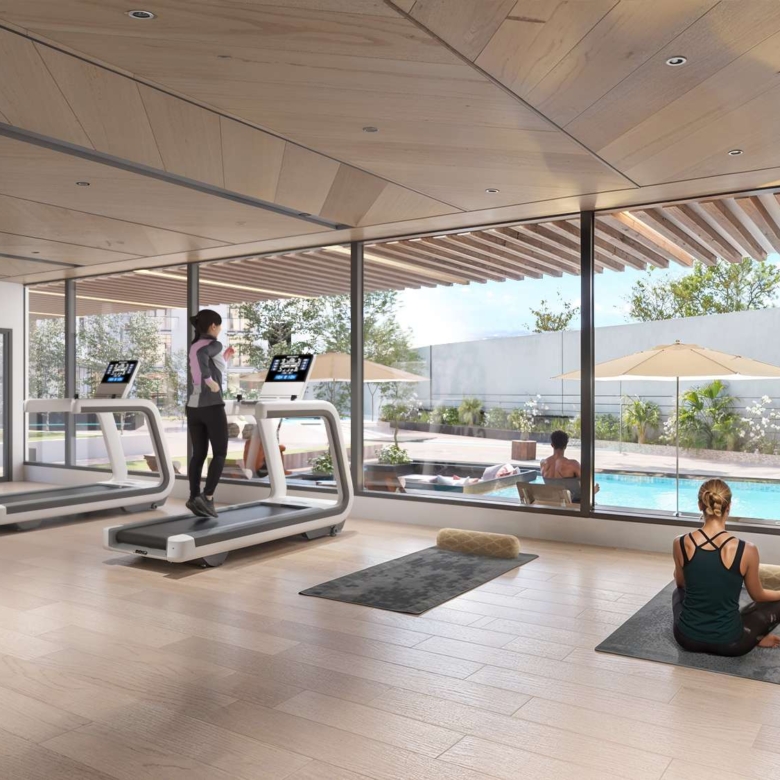 Fully equipped gym at Aya Luxury Residences overlooking the swimming pool
