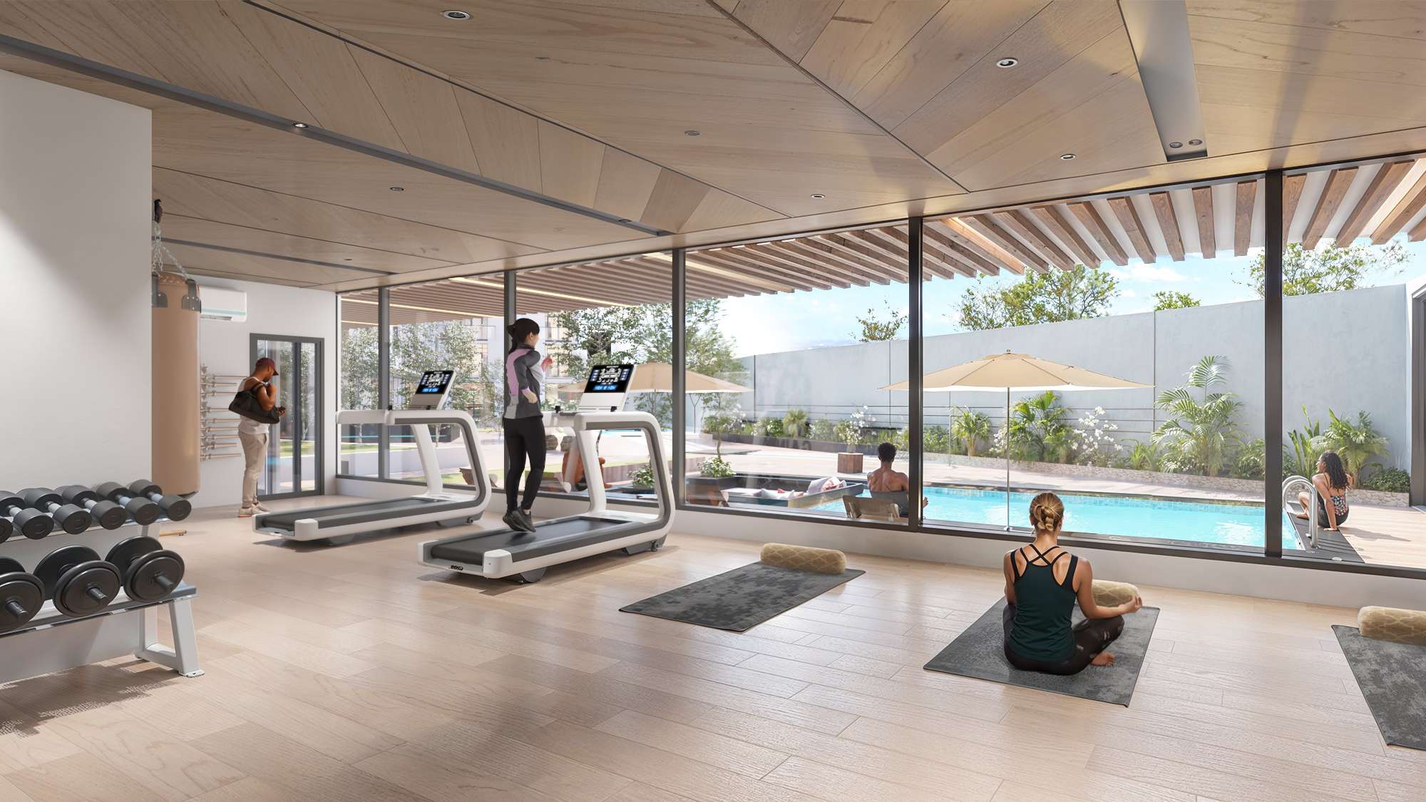 Fully equipped gym at Aya Luxury Residences overlooking the swimming pool