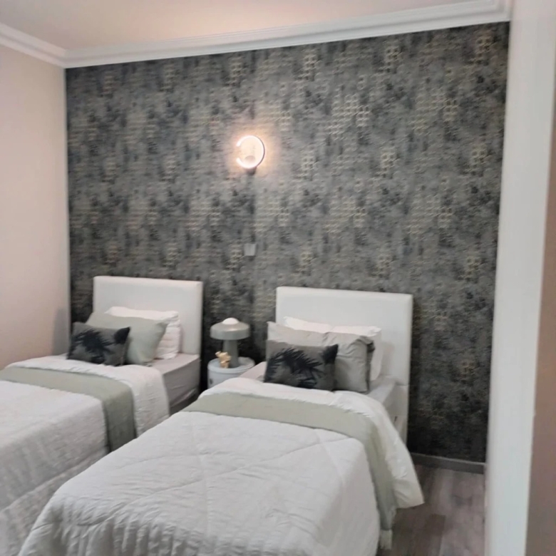 Twin bedroom interior at Plumeria Residency apartments in Kilimani