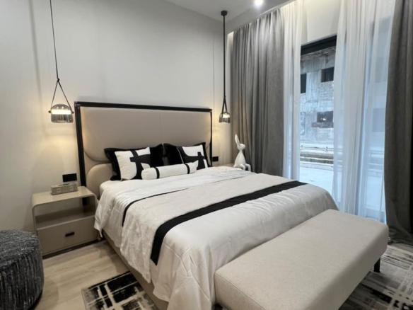 Furnished bedroom at Verona Apartments Westlands with large windows and full-length curtains