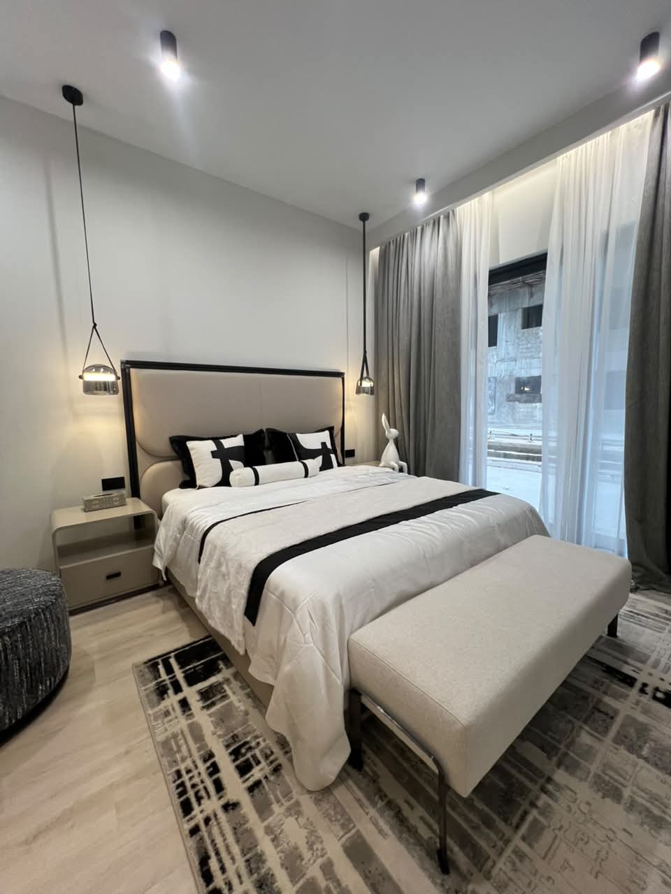 Verona Apartments Bedroom With Large Windows Furnished bedroom at Verona Apartments Westlands with large windows and full-length curtains