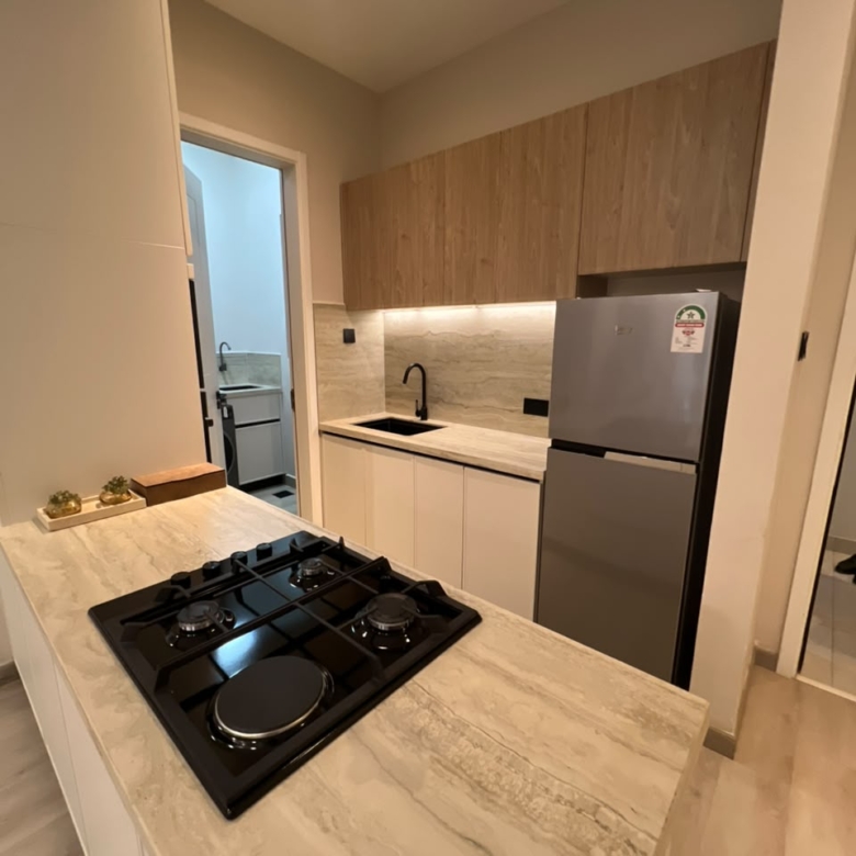 Compact fitted kitchen at Verona Apartments Westlands with a refrigerator and gas hob