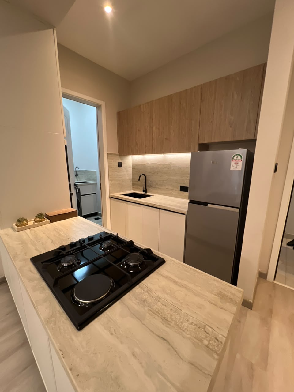 Compact fitted kitchen at Verona Apartments Westlands with a refrigerator and gas hob