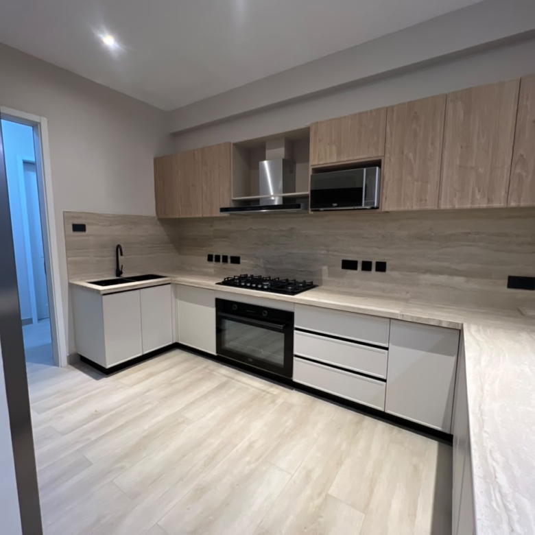 Modern fitted kitchen at Verona Apartments Westlands with an oven, hob and wooden cabinets