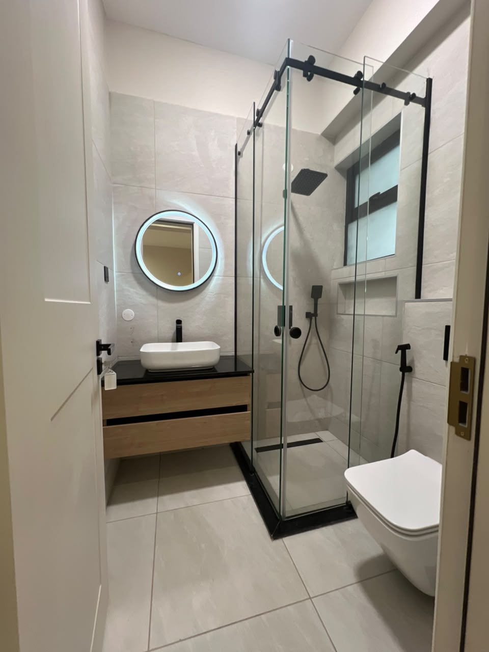 Bathroom at Verona Apartments Westlands with an enclosed glass shower and modern black fixtures