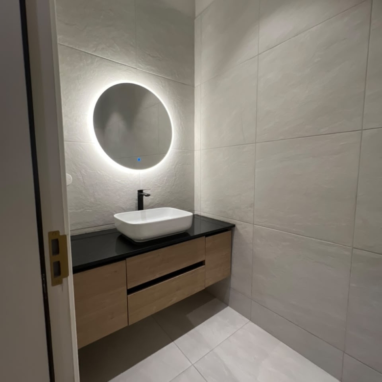 Guest washroom at Verona Apartments Westlands with a floating vanity and illuminated mirror