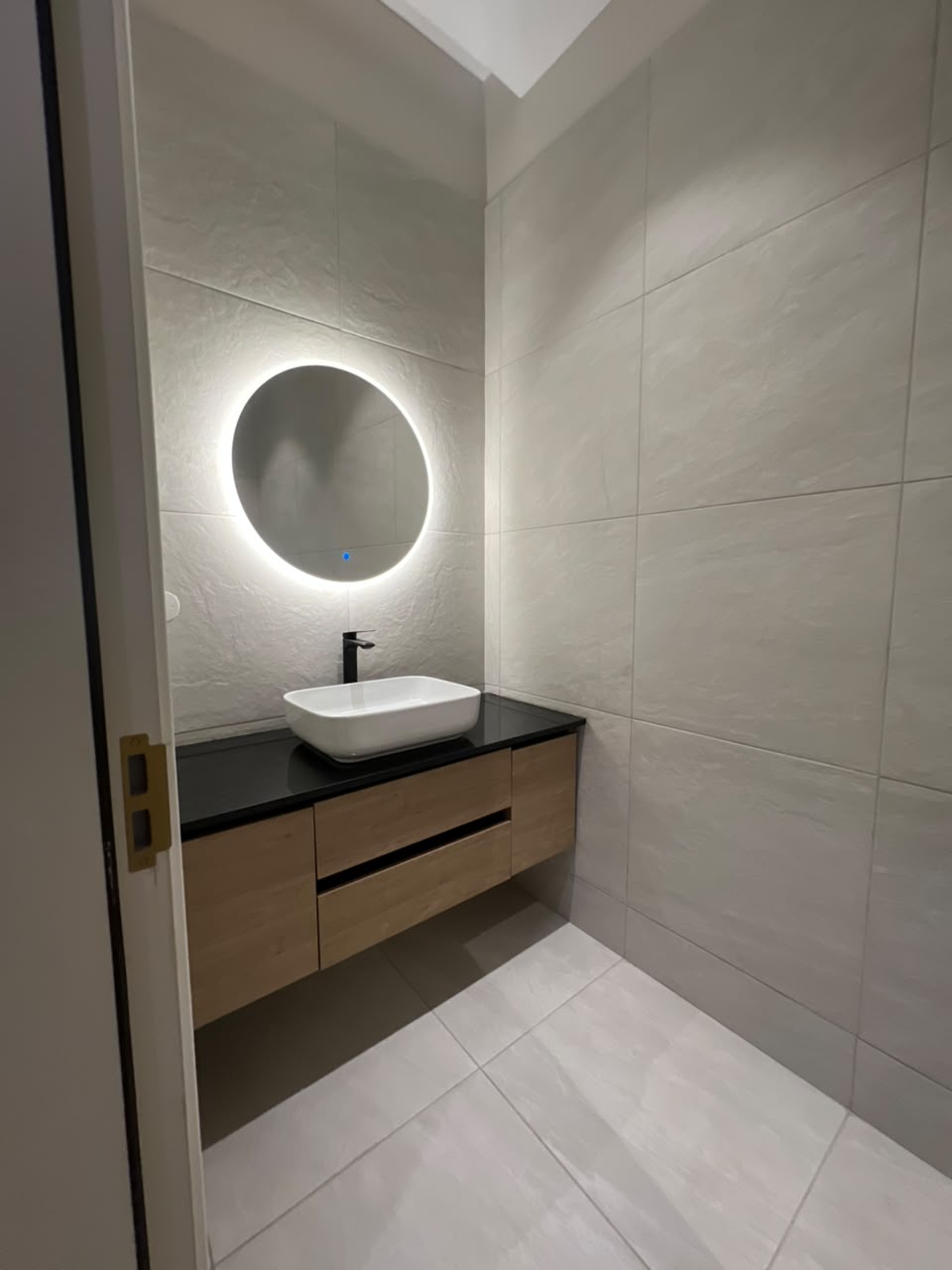 Guest washroom at Verona Apartments Westlands with a floating vanity and illuminated mirror