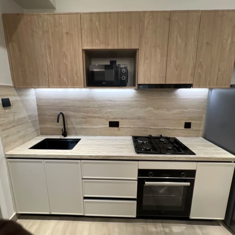 Fitted kitchen at Verona Apartments Westlands with a gas hob, oven and microwave