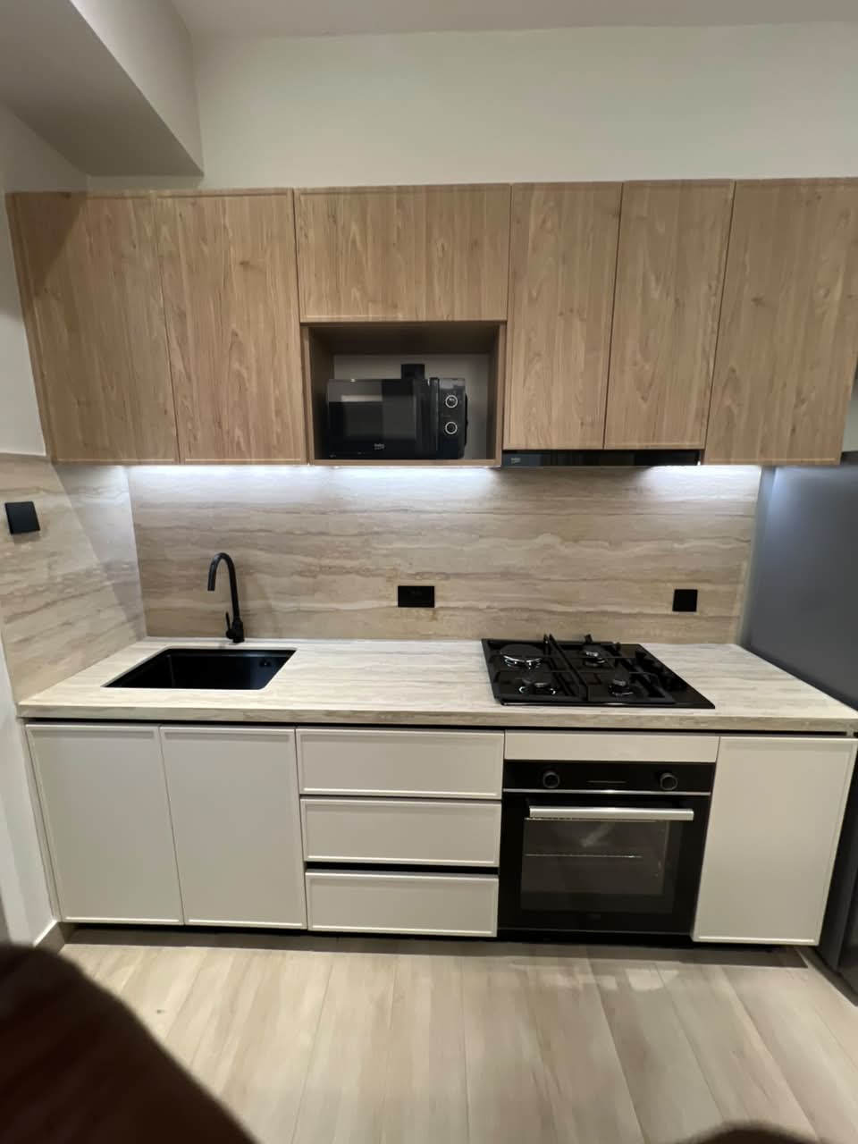 Fitted kitchen at Verona Apartments Westlands with a gas hob, oven and microwave