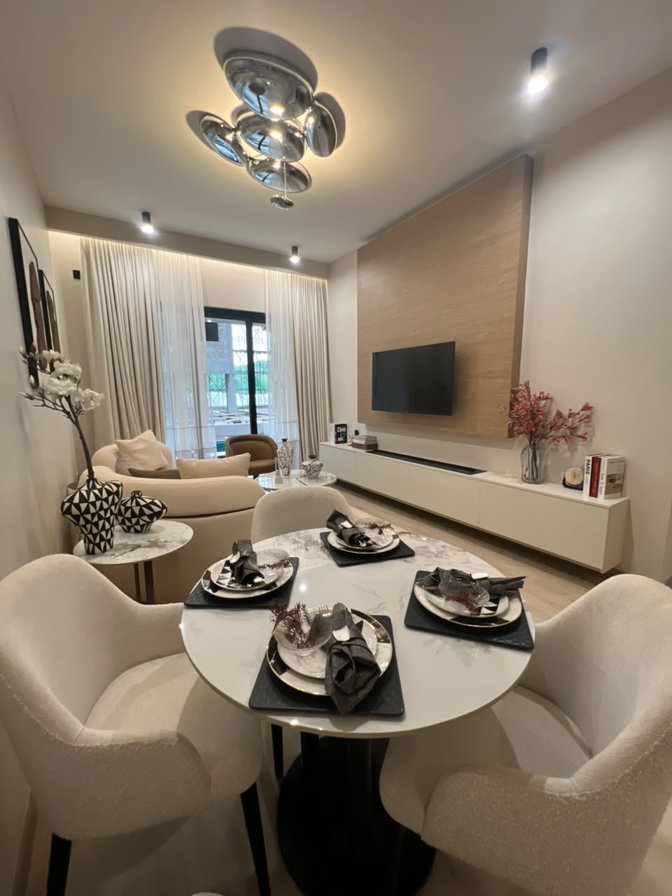 Furnished living and dining room at Verona Apartments Westlands with a modern television wall