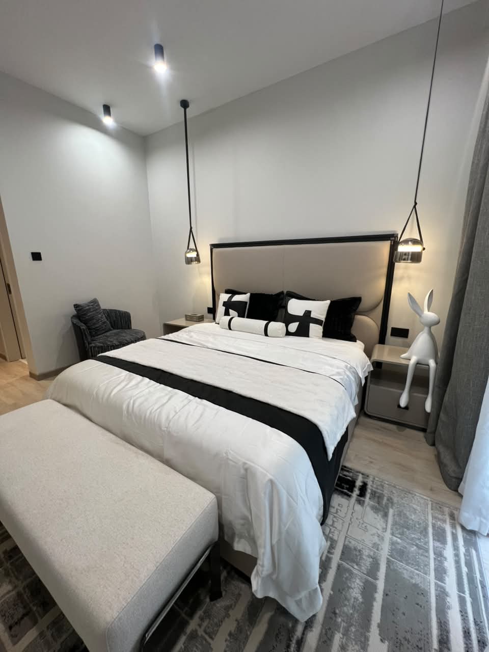 Modern bedroom at Verona Apartments Westlands with pendant lights and an upholstered headboard