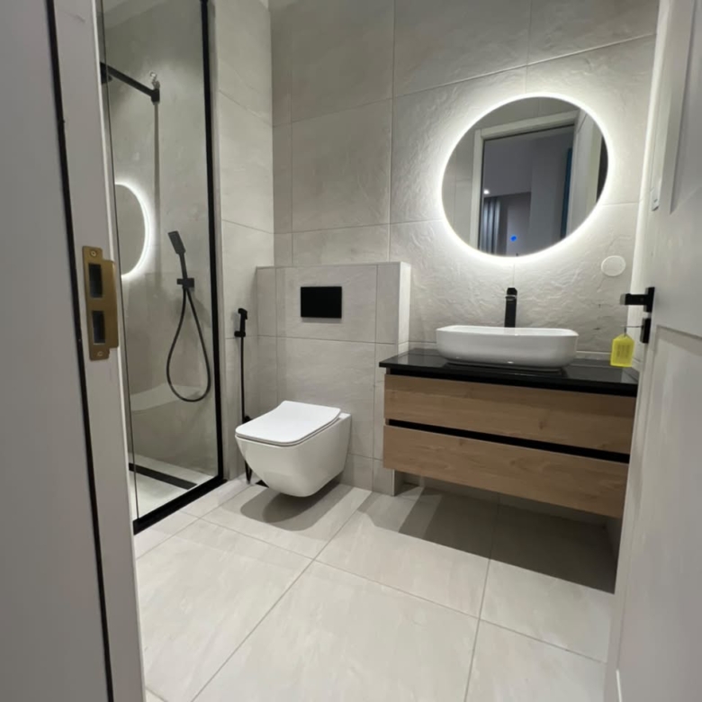 Modern ensuite bathroom at Verona Apartments Westlands with a glass shower and illuminated mirror