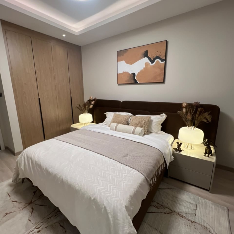 Contemporary bedroom at Verona Apartments Westlands with an upholstered bed and fitted wardrobes