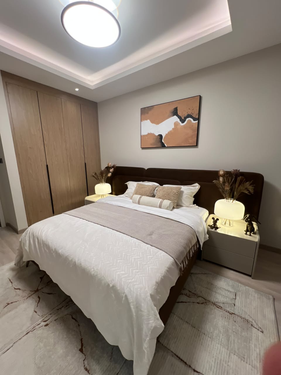 Contemporary bedroom at Verona Apartments Westlands with an upholstered bed and fitted wardrobes