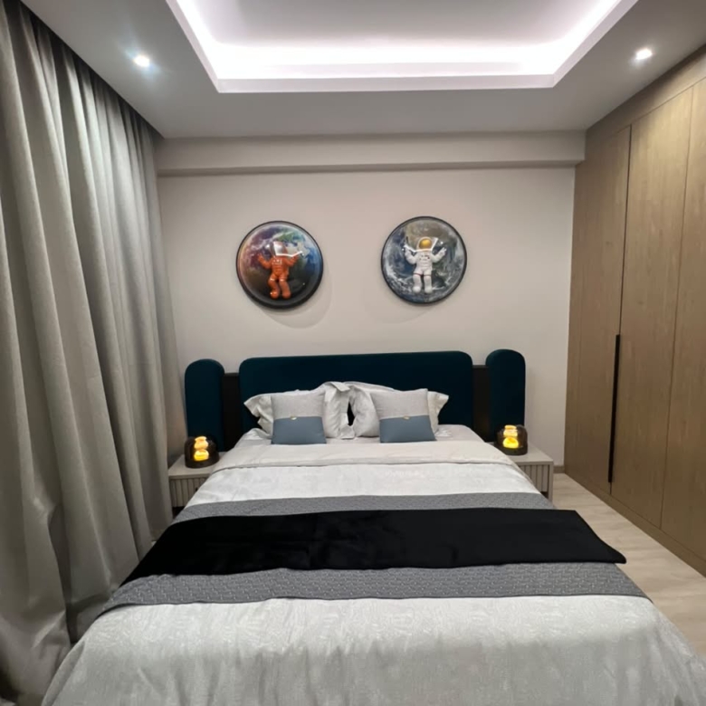 Front view of a furnished bedroom at Verona Apartments Westlands with a teal headboard