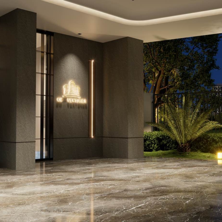Oxford Homes Residency main entrance exterior showing a modern high-rise façade, gated driveway, landscaped frontage, and contemporary architectural finishes.