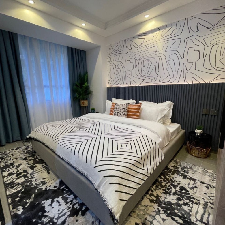 Contemporary bedroom with patterned feature wall at Padmore Residency