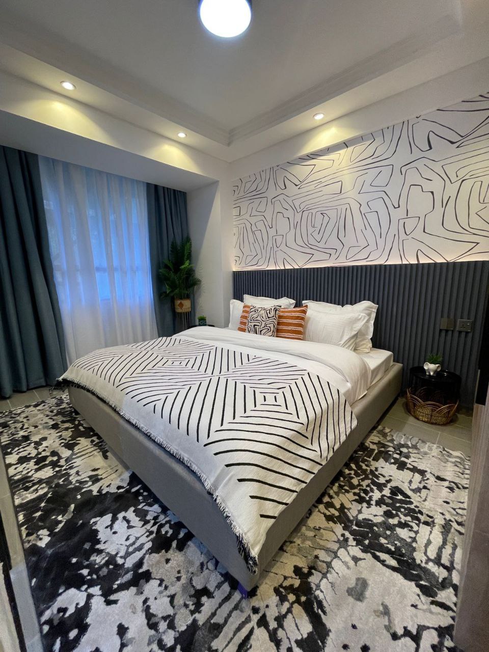 Contemporary bedroom with patterned feature wall at Padmore Residency