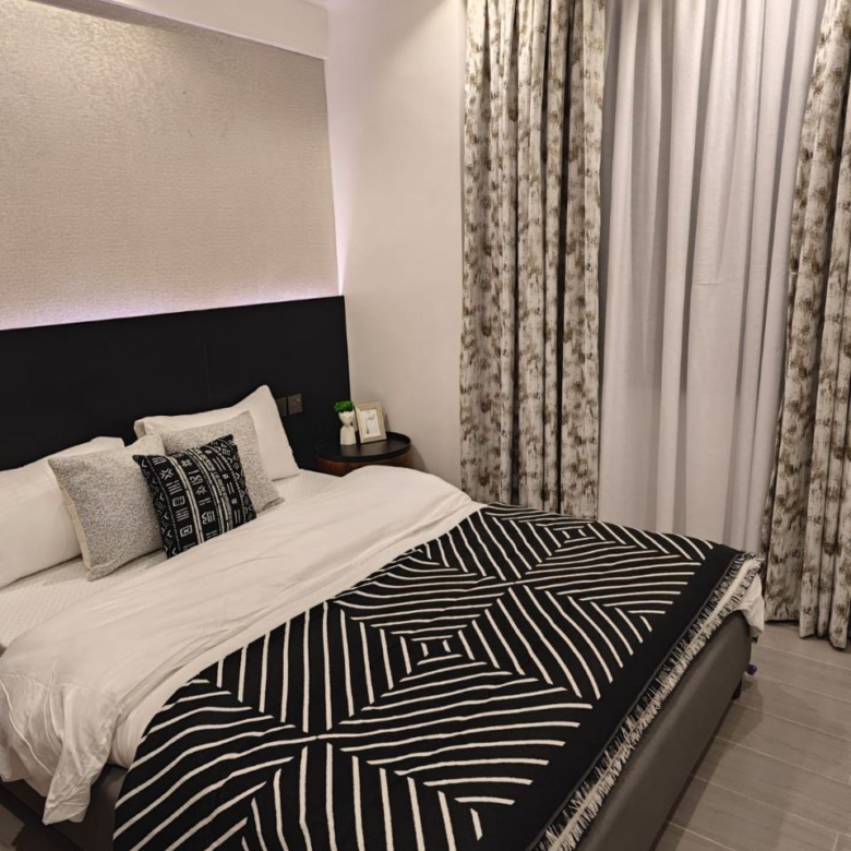 Black and white furnished bedroom at Padmore Residency Kilimani