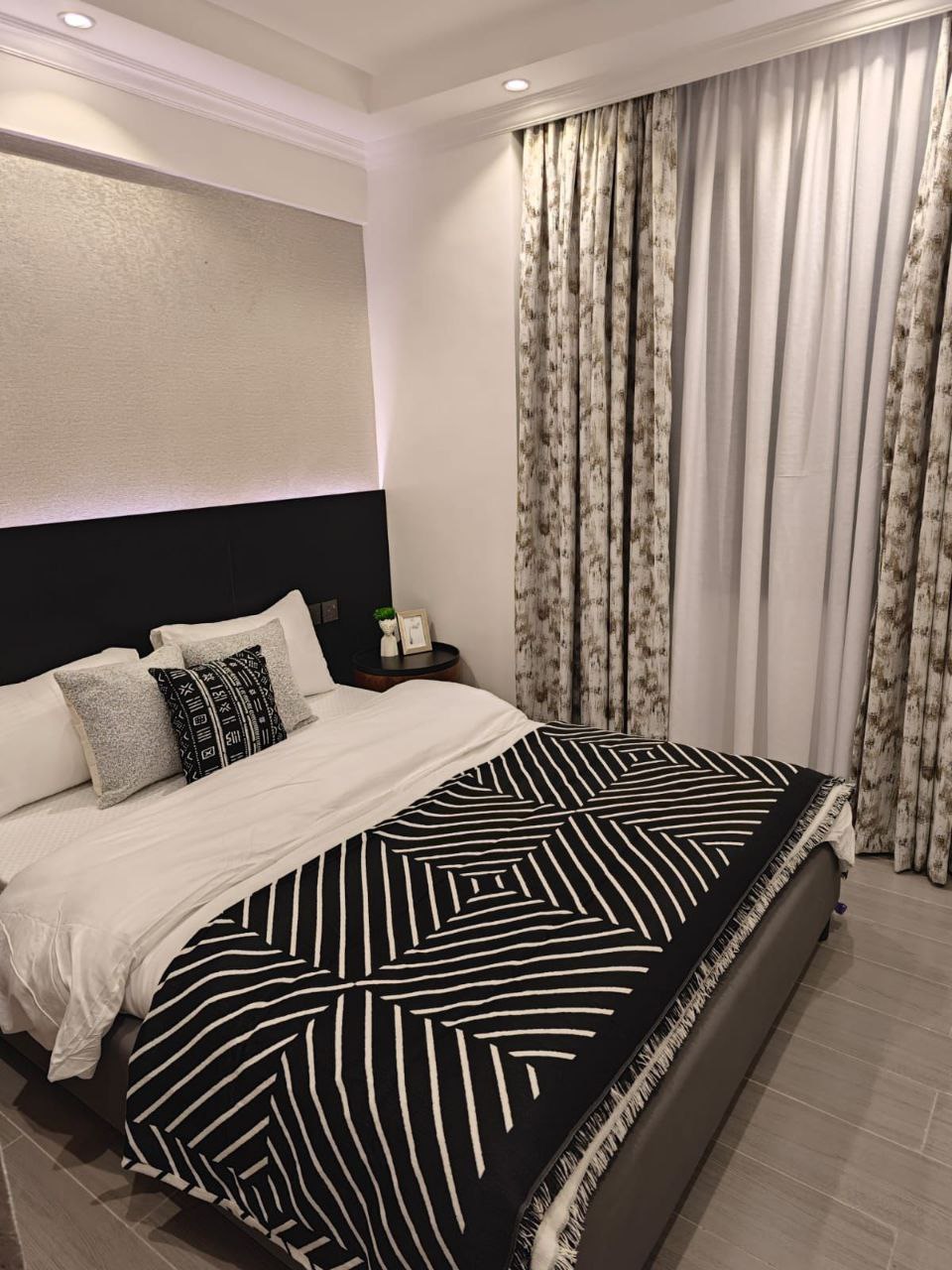 Black and white furnished bedroom at Padmore Residency Kilimani