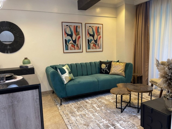 Furnished apartment lounge with green sofa at Padmore Residency