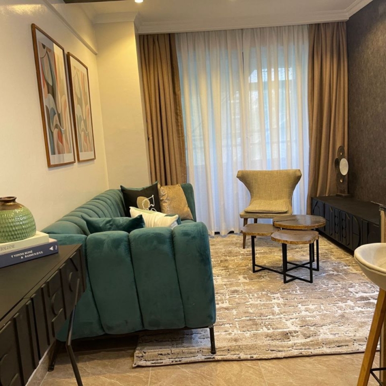 Contemporary lounge with green sofa at Padmore Residency