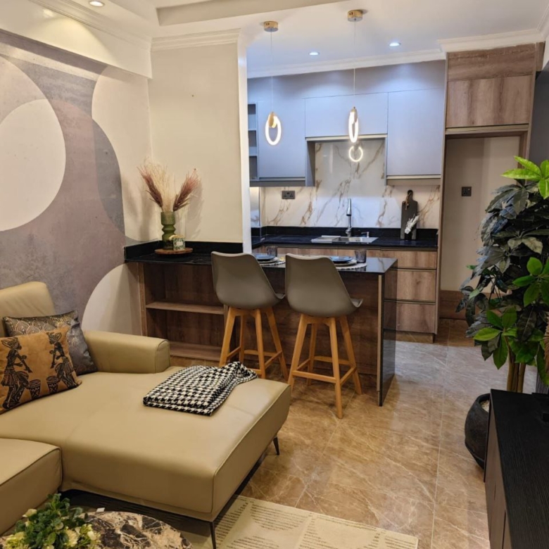 Fitted kitchen with breakfast bar and lounge at Padmore Residency