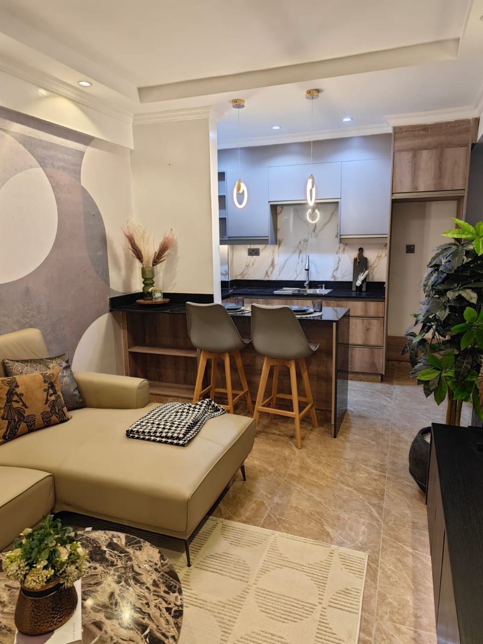 Fitted kitchen with breakfast bar and lounge at Padmore Residency