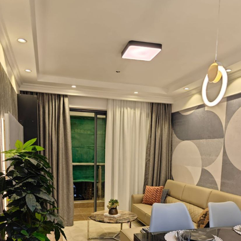 Living and dining room with balcony access at Padmore Residency Kilimani