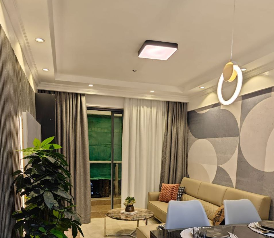 Living and dining room with balcony access at Padmore Residency Kilimani