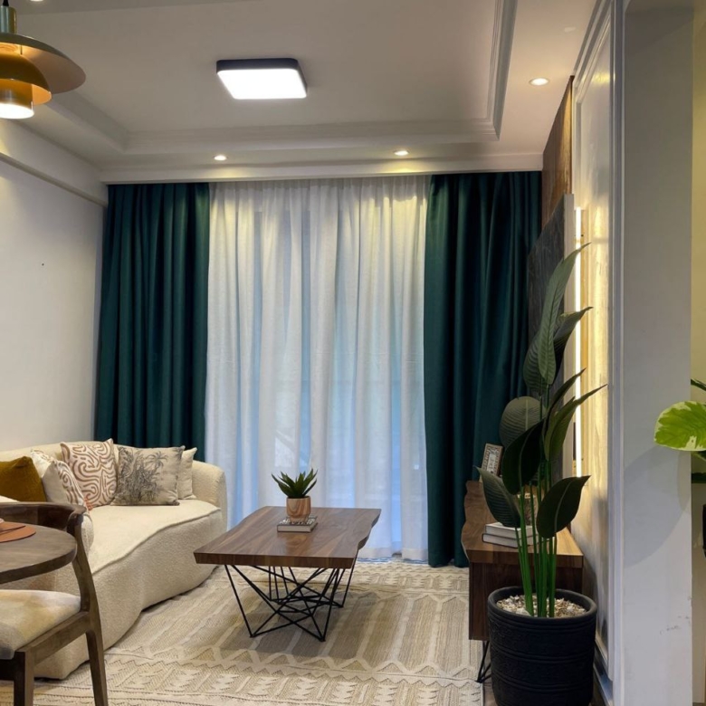 Furnished living room with balcony access at Padmore Residency Kilimani