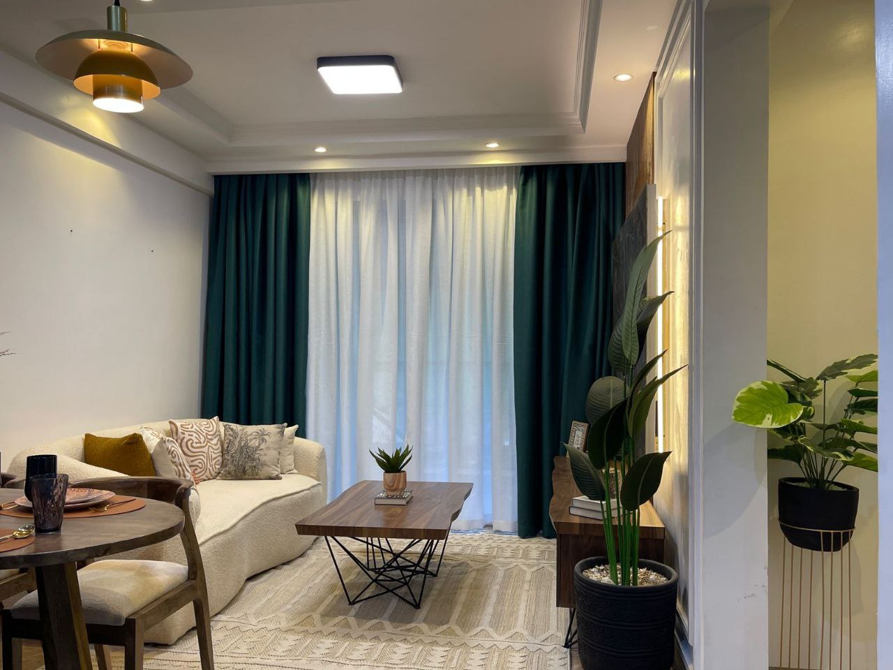 Furnished living room with balcony access at Padmore Residency Kilimani