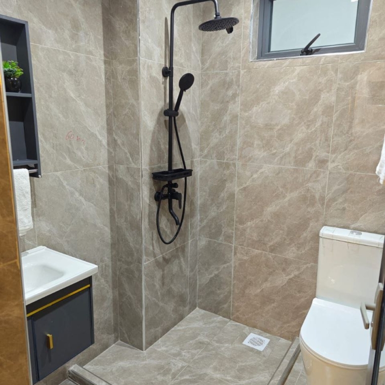 Modern tiled bathroom with rainfall shower at Padmore Residency
