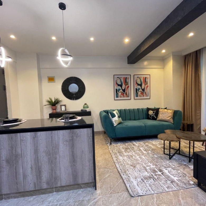 Open kitchen and furnished living room at Padmore Residency Kilimani