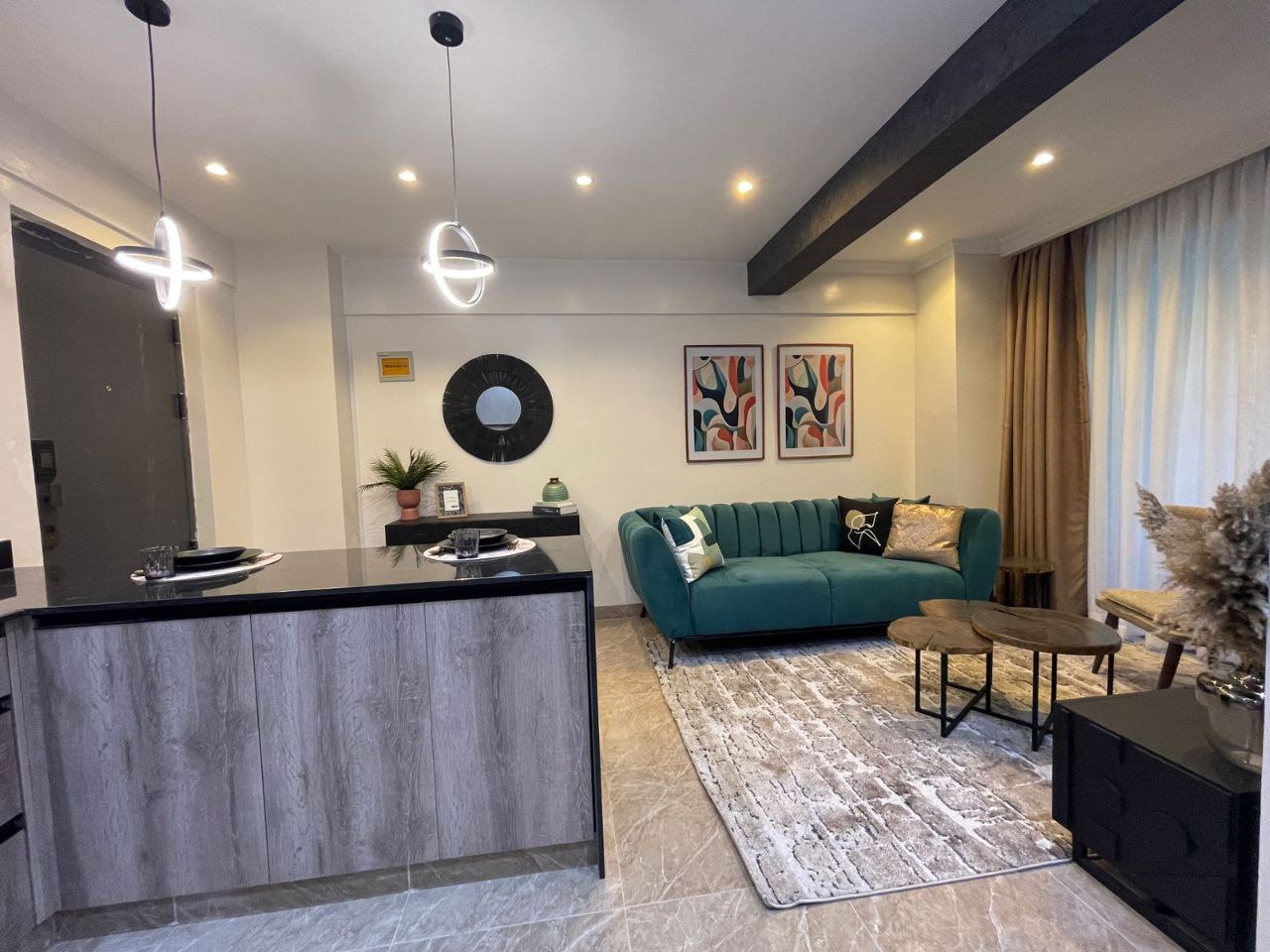Open kitchen and furnished living room at Padmore Residency Kilimani