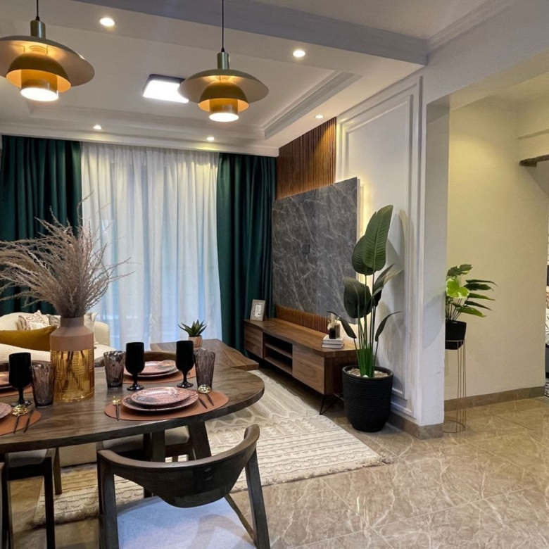 Open-plan living and dining area with bedroom access at Padmore Residency