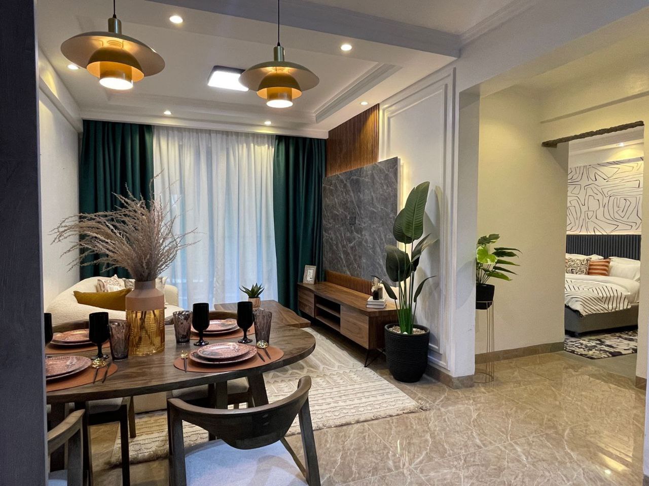 Open-plan living and dining area with bedroom access at Padmore Residency