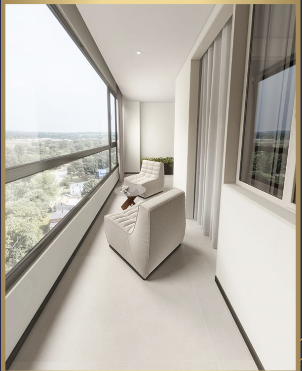 Superwest View Apartments enclosed balcony featuring two white lounge chairs, a small coffee table, full-height glass windows, and elevated neighbourhood views.