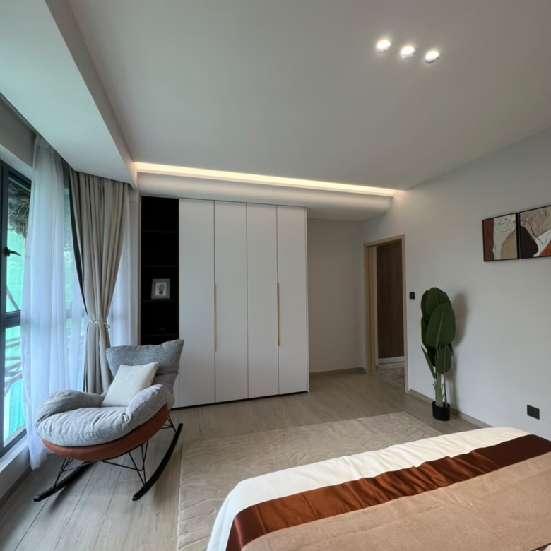 Bedroom wardrobe and sitting area at Golfscape Residences Kilimani apartments