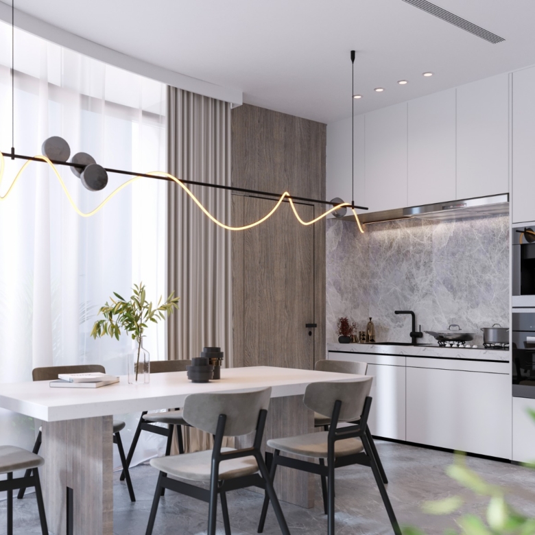 Fountain Residency dining area featuring a modern white dining table, upholstered chairs, designer pendant lighting, and a fitted kitchen with integrated appliances.