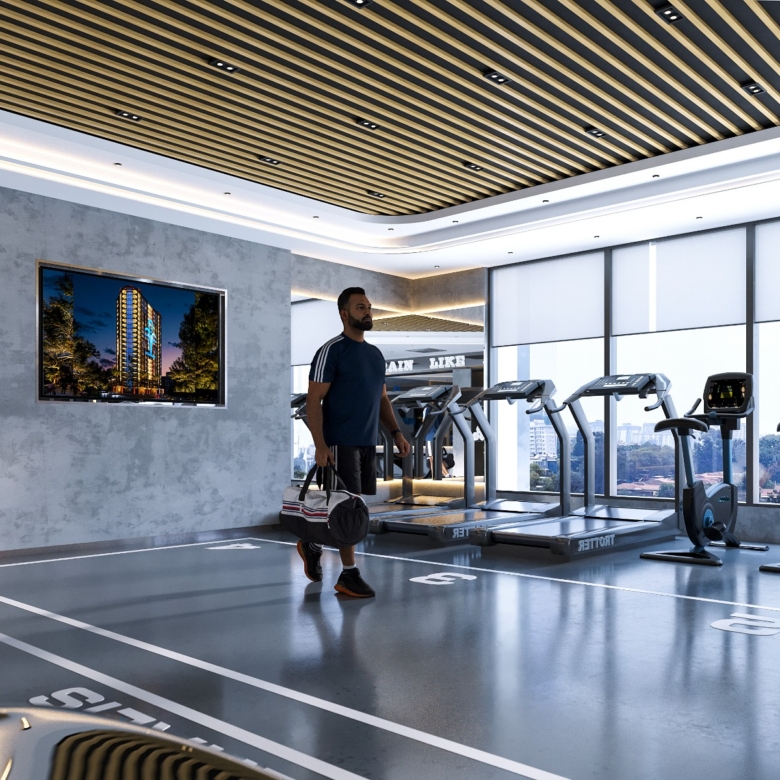 Fountain Residency modern fitness gym featuring treadmills, stationary exercise bikes, floor-to-ceiling windows, contemporary lighting, and a spacious workout area.