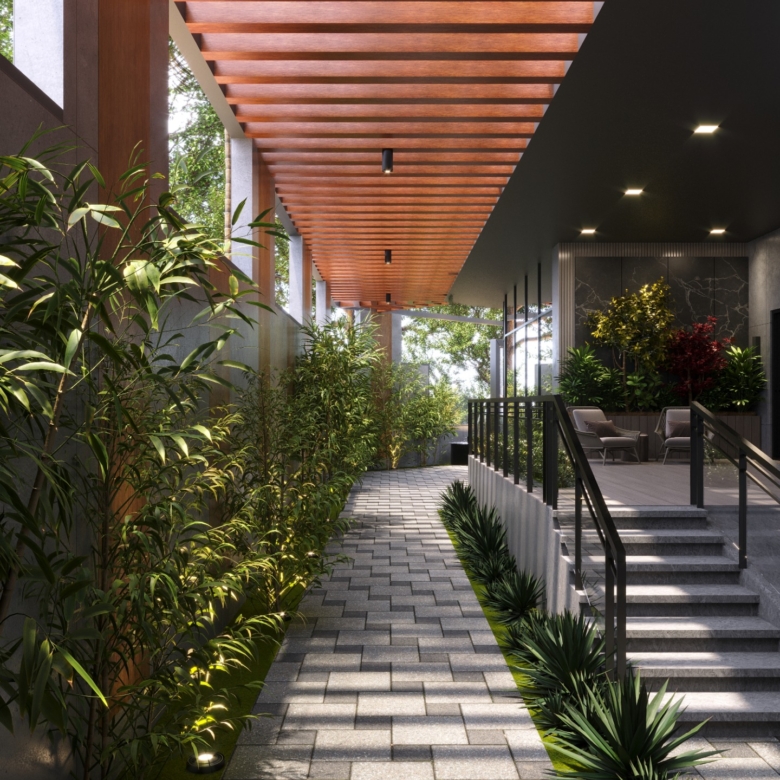 Fountain Residency landscaped garden walkway featuring lush green plants, a wooden pergola, paved pathways, outdoor seating, and decorative garden lighting.