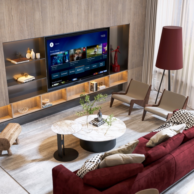 Fountain Residency modern living room featuring a burgundy sofa, marble-look coffee table, wall-mounted television, accent chairs, and contemporary interior finishes.