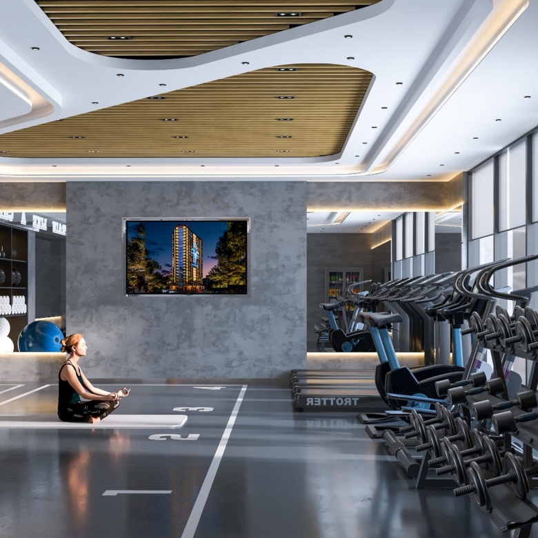 Fountain Residency fitness centre featuring gym storage shelves, exercise balls, yoga mats, kettlebells, modern lighting, and an open training area.